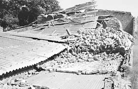 A view of the collapsed godown of a rice mill following an earthquake in Moga