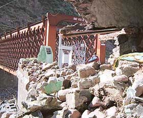 Boulders block the damaged “Lal Pull” on the Uri-Muzzaffarabad road which will take a long time to be repaired