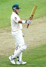 Matthew Hayden of Australia raises his bat after scoring a century during the Super Series Test match against World XI