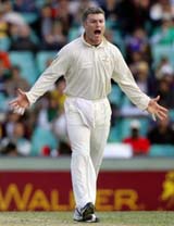 Australia�s Stuart MacGill celebrates taking the wicket of World XI player Andrew Flintoff on the second day of the Super Test at the Sydney Cricket Ground
