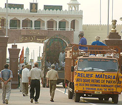 Relief material from India being loaded into a Pakistani truck at the Wagah check-post on Sunday.
