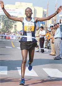 Kenyan athlete Philip Rugut is the first to cross the finish line of the Delhi Half Marathon in New Delhi on Sunday.