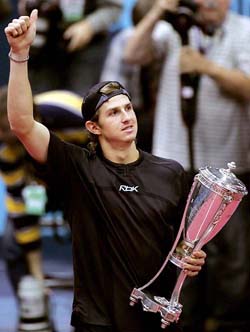 Igor Andreev of Russia holds the trophy after winning the Kremlin Cup in Moscow on Sunday