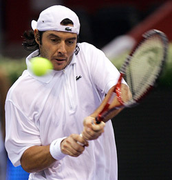 Sebastien Grosjean of France plays a return shot during his match against Feliciano Lopez of Spain in the first round of the Madrid Masters Series on Monday