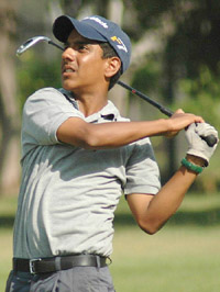 Rahul Bakshi watches the line of the ball on the second shot on the 18th fairway in the first round of the Royal Challenge Samarvir Sahi Golf Tournament at the Chandigarh Golf Club on Tuesday