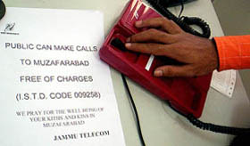 A man dials the number of his relative living in PoK capital Muzaffarabad at the Jammu telephone exchange