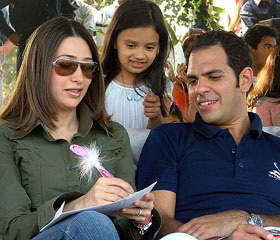 Karishma Kapoor with her husband Sanjay Kapur giving autograph to a girl at the final match of the Samaira Polo Cup-2005, at Jaipur Polo Ground in New Delhi on Sunday