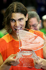 Rafael Nadal of Spain bites the Masters Series Madrid trophy after beating Croatia's Ivan Ljubicic in the final in Madrid