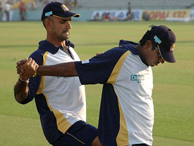 Marvan Atapattu and Chaminda Vaas do stretching exercises at the PCA Stadium in Mohali on Thursday