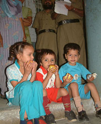 Children in the Central Jail, Amritsar, enjoy a treat of apples during the visit of Kumari Selja, Union Minister of State for Urban Employment and Poverty Alleviation, to the prison on Friday. 