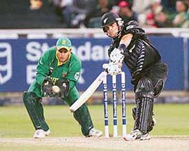 New Zealand batsman Lou Vincent plays a shot as South Africa wicketkeeper Mark Boucher looks on during the second one-dayer at the Newlands stadium in Cape Town on Friday