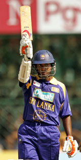 Sri Lanka�s Kumar Sangakkara raises his bat after completing his century against India during their third one-day international in Jaipur on Monday