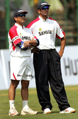 Sachin Tendulkar and Rahul Dravid watch their team-mates at a practice session in Pune on Wednesday