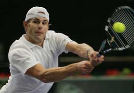 Andy Roddick of the USA plays a shot during his match against compatriot Taylor Dent in the second round of the Paris Masters on Wednesday