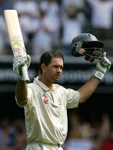 Ricky Ponting of Australia raises his bat after scoring a century during the first day of the first Test against the West Indies in Brisbane on Thursday