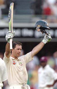 Ricky Ponting of Australia raises his bat after scoring a century during the third day of the first Test against the West Indies in Brisbane on Saturday. 