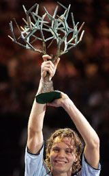 Tomas Berdych of the Czech Republic holds his trophy after beating Ivan Ljubicic of Croatia in the final of Paris Tennis Masters Series on Sunday