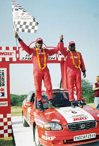 Arjun Rao Aroor and co-driver M Chandramouli celebrate after winning the fifth round of the MAI Indian National Rally Championship at Surajkund, near New Delhi, on Sunday