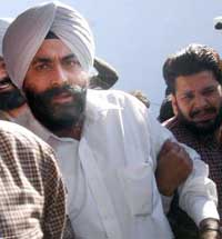 Mr S.P. Singh (left), Amritsar Central Jail Superintendent, in police custody in Amritsar on Thursday.