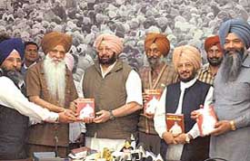 The Chief Minister, Capt Amarinder Singh, releases a book on G. S. Tohra by Prof Balkar Singh in Chandigarh on Thursday