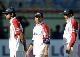 Rahul Dravid, Sachin Tendulkar and Virender Sehwag walk during a practice session in Bangalore on Friday