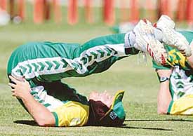 South African captain Graeme Smith stretches during a practice session in Bangalore on Friday