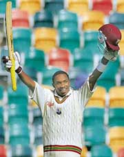 West Indies batsman Dwayne Bravo celebrates on scoring a century on the fourth day of the second Test against Australia in Hobart on Sunday.