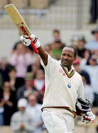 Brian Lara celebrates after becoming the most prolific run-scorer in Test cricket during the second day of the third Test against Australia in Adelaide 