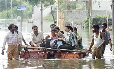 Residents are transported by a makeshift raft in Chennai on Sunday. Cyclone Baaz, which was hovering in the Bay of Bengal, weakened into a depression but brought rain to drench the southern metropolis.