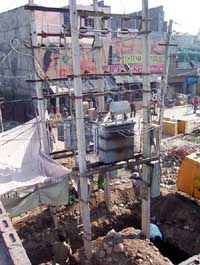 Labourers dig the foundation of poles of a PSEB transformer on the Gulmohar Tourist Complex road in Pathankot