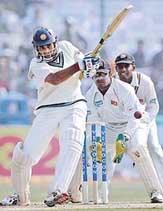 VVS Laxman plays a shot as Sri Lanka�s wicketkeeper Kumar Sangakkara and Thilan Samaraweera look on during the first day of the second Test in New Delhi on Saturday.