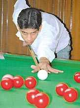  Sumit Talwar attempts to pot the ball during the final of the Chandigarh State Billiards and Snooker Championship at Sector 22 Billiards Coaching Centre on Sunday. 