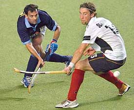 Viren Rasquinha (left) flicks the ball past Germany�s Justus Scharowsky during their Champions Trophy match in Chennai on Wednesday. 