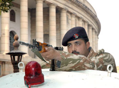 A security personnel takes position at Parliament House after a bomb scare on Friday.