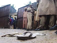 Slippers of stampede victims lie on a road in Chennai on Sunday.