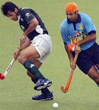 Prabhjot Singh runs past Pakistan�s Muhammad Saqlain during a Champions Trophy classification match for the fifth place in Chennai