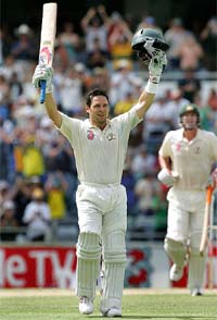 Brad Hodge of Australia celebrates after reaching his double century during the fourth day of the first Test against South Africa in Perth