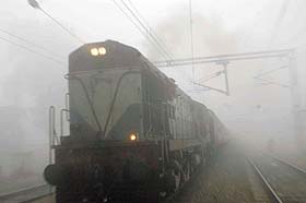 A passenger train steams into Jalandhar railway station hours behind schedule due to foggy conditions on Friday morning