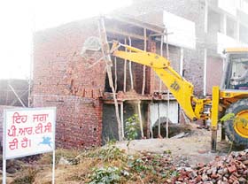 Illegal structures being demolished in Urban Estate area on Rajpura road in Patiala