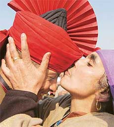 A mother kisses her son at the passing out parade of recruits of the JAKLI at the regimental centre at Rangreth (Srinagar)