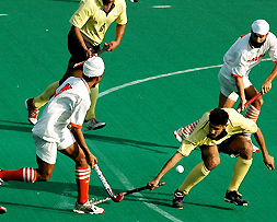 A Punjab and Sind Bank player tries to thwart a move by Namdhari XI players in the final of the SN Vohra�s 35th All-India Gurmit Memorial Hockey Tournament in Chandigarh on Saturday