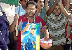 Supporters of Sourav Ganguly celebrate in front of his residence in Kolkata on Saturday