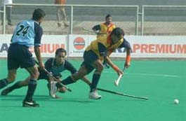 An EME player tries to get past RCF�s full-back during the opening match of the Surjit Memorial Hockey Tournament in Jalandhar