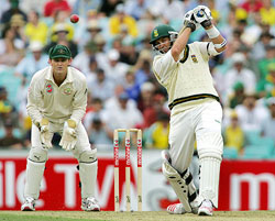 South African batsman Jacques Kallis plays a shot as Australian wicketkeeper Adam Gilchrist looks on during the first day of the third and final Test in Sydney on Monday. 