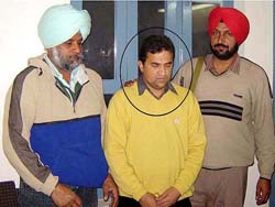 Munish Narula, District Food and Supply Controller (centre), who has been arrested by the Vigilance Bureau in Moga. 