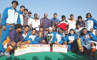 The IA team with the trophy after winning the 22nd Surjit Hockey Tournament in Jalandhar on Thursday
