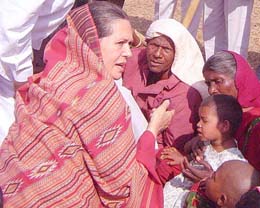 Congress President Sonia Gandhi talks to relatives of the tribal victims who were killed during a clash with the police at Kalinga Nagar during her visit to the area on Wednesday.