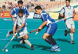 A player of Orissa Steelers tries to dribble past the defence of Lucknow Nawabs 