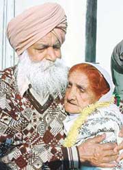 Mr Kesar Singh hugs his sister Rabia Bibi (Agya Kaur) at Attari Railway station on Thursday.