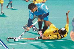 Nitin Kumar of Hyderabad Sultans is checked by Ajmer Singh of Sher-e-Jallandhar during a Tier I match of the Premier Hockey League at the Sector 42 Hockey Stadium in Chandigarh on Thursday